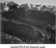 View of wooded hills with mountains in background, "In Rocky Mountain National Park," Colorado.  Photographs of National Parks and Monuments, compiled 1941 - 1942, documenting the period ca. 1933 - 1942.