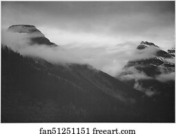 Mountain partially covered with clouds, "In Glacier National Park," Montana.  Photographs of National Parks and Monuments, compiled 1941 - 1942, documenting the period ca. 1933 - 1942.