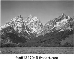 Grassy valley, tree covered mountain side and snow covered peaks, Grand "Teton National Park", Wyoming.  Photographs of National Parks and Monuments, compiled 1941 - 1942, documenting the period ca. 1933 - 1942.